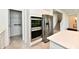 View of stainless steel appliances and a pantry in a kitchen with quartz countertops at 7147 Buckley Branch Dr, Indianapolis, IN 46259