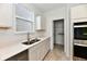 Kitchen featuring quartz countertops, stainless steel appliances, and a view of the backyard at 7147 Buckley Branch Dr, Indianapolis, IN 46259