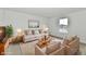 Comfortable living room with neutral sofas, stylish decor, and inviting layout, with ample sunlight at 7147 Buckley Branch Dr, Indianapolis, IN 46259