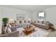 Spacious living room with neutral sofas and a plush rug, illuminated by natural light at 7147 Buckley Branch Dr, Indianapolis, IN 46259