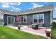 This outdoor patio provides a welcoming area with comfortable seating, a fire pit, and a vibrant outdoor rug at 7184 Lillian Pl, Cumberland, IN 46229