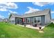 Outdoor patio offers a great space for entertaining with a seating area and a cozy fire pit at 7184 Lillian Pl, Cumberland, IN 46229