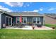 Landscaped backyard includes a patio set, seating, and a well-maintained lawn at 7184 Lillian Pl, Cumberland, IN 46229