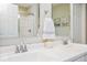 Bright bathroom featuring a double sink vanity with chrome fixtures and a shower with glass door at 7184 Lillian Pl, Cumberland, IN 46229