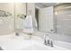Bright bathroom featuring a double sink vanity with chrome fixtures and a shower with glass door at 7184 Lillian Pl, Cumberland, IN 46229