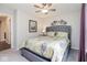 Cozy bedroom with patterned quilt, a ceiling fan, and a window with curtains at 7184 Lillian Pl, Cumberland, IN 46229