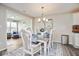 Charming dining room with a chandelier and elegant table setting for six at 7184 Lillian Pl, Cumberland, IN 46229