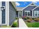 Inviting front walkway leading to home with stone accents and vibrant landscaping at 7184 Lillian Pl, Cumberland, IN 46229