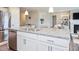 Modern kitchen island featuring granite countertops and stainless steel dishwasher at 7184 Lillian Pl, Cumberland, IN 46229