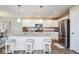Stylish kitchen featuring white cabinetry, stainless steel appliances, and island with seating at 7184 Lillian Pl, Cumberland, IN 46229