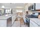 Well-lit kitchen showcases stainless steel appliances and an open view to the dining area at 7184 Lillian Pl, Cumberland, IN 46229