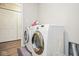 Functional laundry room equipped with modern washer and dryer units and closet at 7184 Lillian Pl, Cumberland, IN 46229