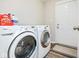 Functional laundry room equipped with modern washer and dryer units and exterior door at 7184 Lillian Pl, Cumberland, IN 46229