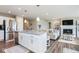 Open-concept living room featuring an island kitchen, fireplace, and comfortable seating at 7184 Lillian Pl, Cumberland, IN 46229