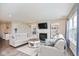 Inviting living room featuring a fireplace, built-in shelving, and lots of natural light at 7184 Lillian Pl, Cumberland, IN 46229