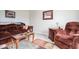 Comfortable living room features a plush sofa, an armchair, and neutral-toned walls for a relaxing atmosphere at 7184 Lillian Pl, Cumberland, IN 46229