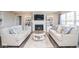 Bright living room with a fireplace, built-in shelves, and two sofas offering ample seating space at 7184 Lillian Pl, Cumberland, IN 46229