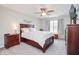 Spacious main bedroom features carpet flooring, ceiling fan, and a large window providing natural light at 7184 Lillian Pl, Cumberland, IN 46229
