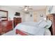 Well-lit main bedroom with dark wood furniture, carpet flooring, and access to a bathroom at 7184 Lillian Pl, Cumberland, IN 46229