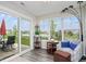 Cozy sunroom with outdoor views, seating area, and access to the patio at 7184 Lillian Pl, Cumberland, IN 46229