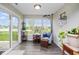 Bright sunroom with a view of the pond, comfortable seating, and lots of natural light at 7184 Lillian Pl, Cumberland, IN 46229
