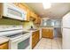 Well-lit kitchen featuring ample counter space, modern appliances, wooden cabinets, and neutral flooring at 7545 Briarstone Dr, Indianapolis, IN 46227