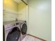 Modern laundry room with side-by-side Samsung washer and dryer, and ample shelving for organized storage at 7545 Briarstone Dr, Indianapolis, IN 46227