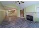 Living room offers wood flooring, a ceiling fan, and a fireplace with a white mantle at 7545 Briarstone Dr, Indianapolis, IN 46227