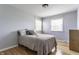 Cozy bedroom featuring hardwood floors, a comfortable bed, and two bright windows at 7935 N County Road 650 E, Brownsburg, IN 46112