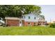 Home's exterior with a brick and siding combination, a grassy lawn, and mature trees at 7935 N County Road 650 E, Brownsburg, IN 46112