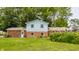 Home's exterior showing the brick and siding features, a grassy lawn, and mature trees at 7935 N County Road 650 E, Brownsburg, IN 46112