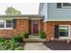 Close-up of front door showing the brick facade and decorative plants at 7935 N County Road 650 E, Brownsburg, IN 46112