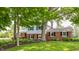 Attractive home with a brick and siding facade, surrounded by lush greenery and mature trees on a well-kept lawn at 7935 N County Road 650 E, Brownsburg, IN 46112