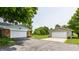 View of a detached two-car garage with asphalt driveway and lawn at 7935 N County Road 650 E, Brownsburg, IN 46112
