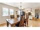 Eat-in kitchen and dining area with a wooden table, natural light, and a view of the kitchen appliances at 7935 N County Road 650 E, Brownsburg, IN 46112