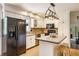 Well-lit kitchen featuring white cabinets, modern appliances, and an island with seating at 7935 N County Road 650 E, Brownsburg, IN 46112