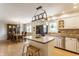 Open kitchen with stainless steel appliances, island with seating, and dining area, creating a functional space at 7935 N County Road 650 E, Brownsburg, IN 46112
