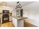 Well-lit kitchen with white cabinetry, an island, and black appliances, perfect for cooking and entertaining at 7935 N County Road 650 E, Brownsburg, IN 46112