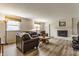 Cozy living room featuring a brick fireplace, comfortable seating, and natural light from the windows at 7935 N County Road 650 E, Brownsburg, IN 46112