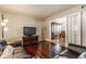 Comfortable living room with hardwood floors, leather seating, and an open doorway to the dining area at 7935 N County Road 650 E, Brownsburg, IN 46112