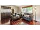 Bright living room with hardwood floors, leather couches, and a built-in bar area for entertaining at 7935 N County Road 650 E, Brownsburg, IN 46112