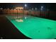Backyard pool illuminated with green lighting and patio furniture; perfect for night swimming and entertaining at 7935 N County Road 650 E, Brownsburg, IN 46112