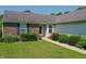 Well-manicured lawn leading to the front entrance with brick and vinyl siding, and updated windows at 7942 Dillon Pl, Indianapolis, IN 46236
