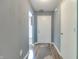 Bright hallway with wood-look vinyl flooring, neutral walls, and a white front door at 7942 Dillon Pl, Indianapolis, IN 46236