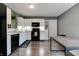 Bright kitchen with white cabinets, black appliances, and a gray countertop at 7942 Dillon Pl, Indianapolis, IN 46236
