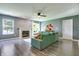 Open-concept living room featuring new vinyl flooring, fresh paint, and a classic gas fireplace at 7942 Dillon Pl, Indianapolis, IN 46236
