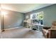 Bright home office with large window, modern desk, neutral walls, and comfortable armchair at 7942 Dillon Pl, Indianapolis, IN 46236