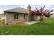 Brick home's backyard with grass, mature landscaping, and patio at 842 Cheltenham Way, Avon, IN 46123