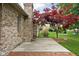Brick home with a patio, chimney, and mature landscaping at 842 Cheltenham Way, Avon, IN 46123