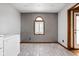 Unfurnished dining room boasts tile floor, textured wallpaper accent wall, and rear exterior access at 842 Cheltenham Way, Avon, IN 46123